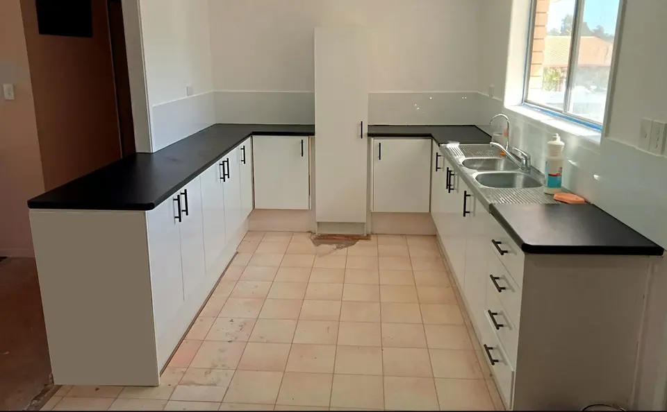 renovated white kitchen with new benchtops