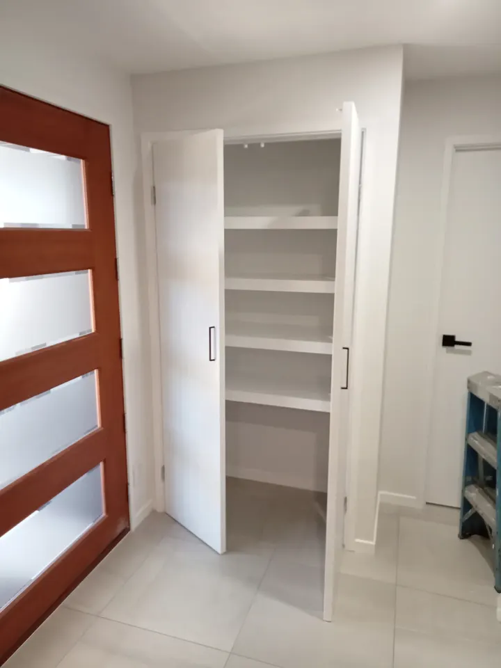 rebuilt linen closet with new shelving and doors