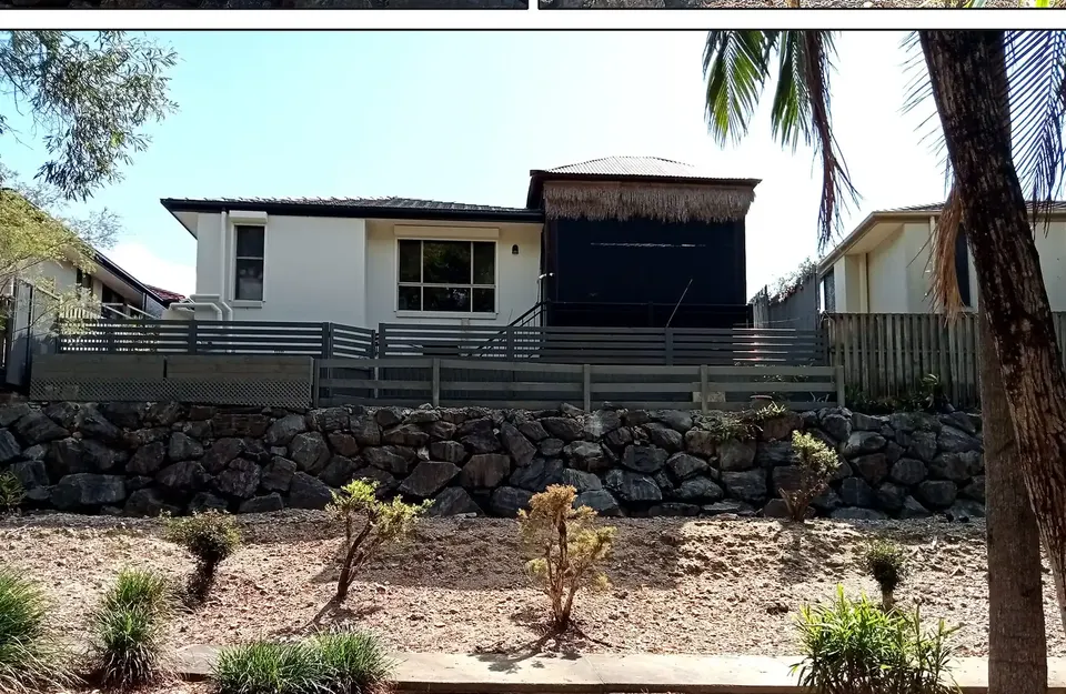 rock retaining wall and replanted garden below a home